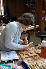 student carving with mallet