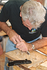 wood carving tools in hand